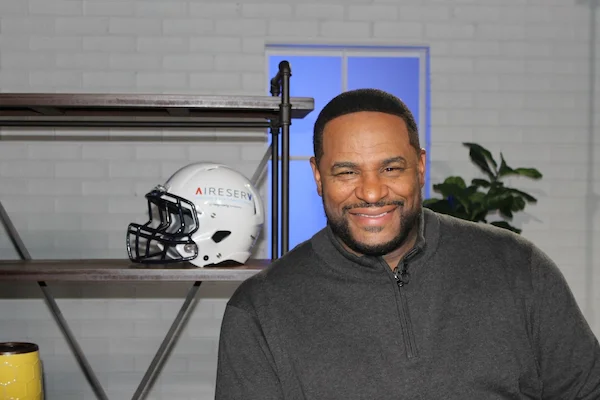 Jerome Bettis beside an Aire Serv branded football helmet.