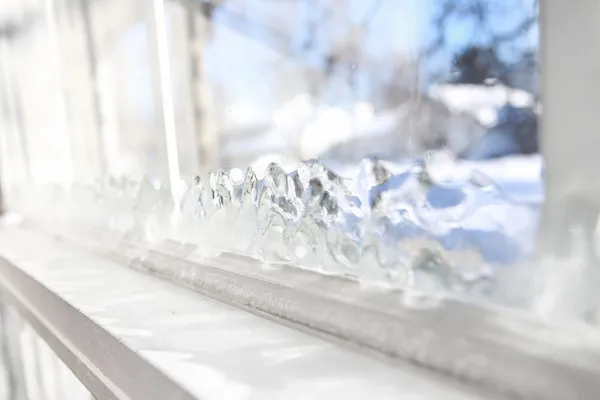 Ice forming on glass window.