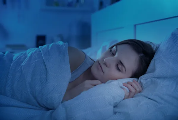 Woman peacefully sleeping in bed.